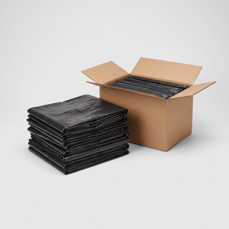 Flat-packed commercial garbage bags stacked beside an open case box