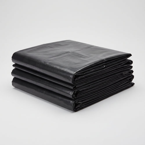Stack of flat-folded black commercial garbage bags