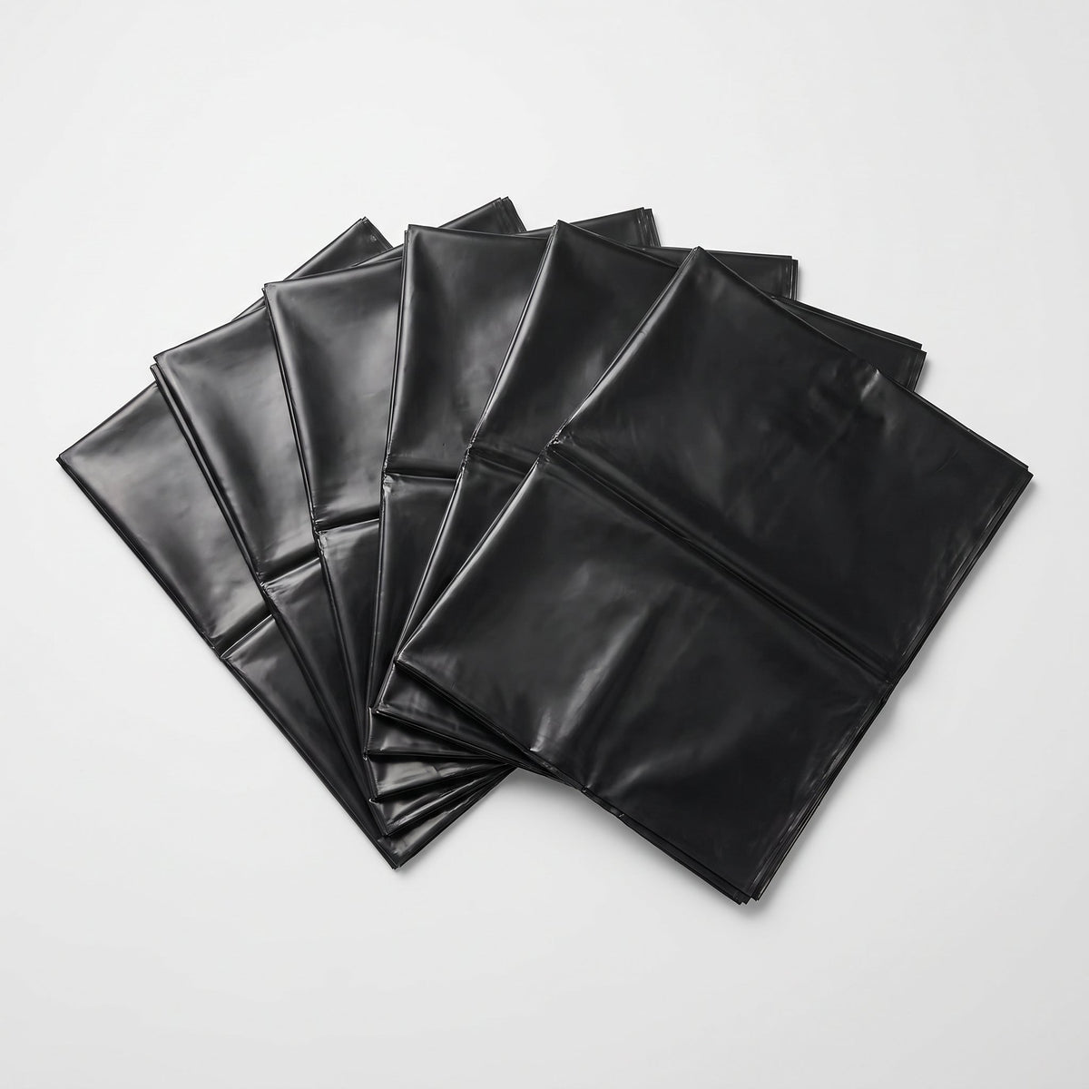 Individual flat-folded commercial garbage bags fanned out